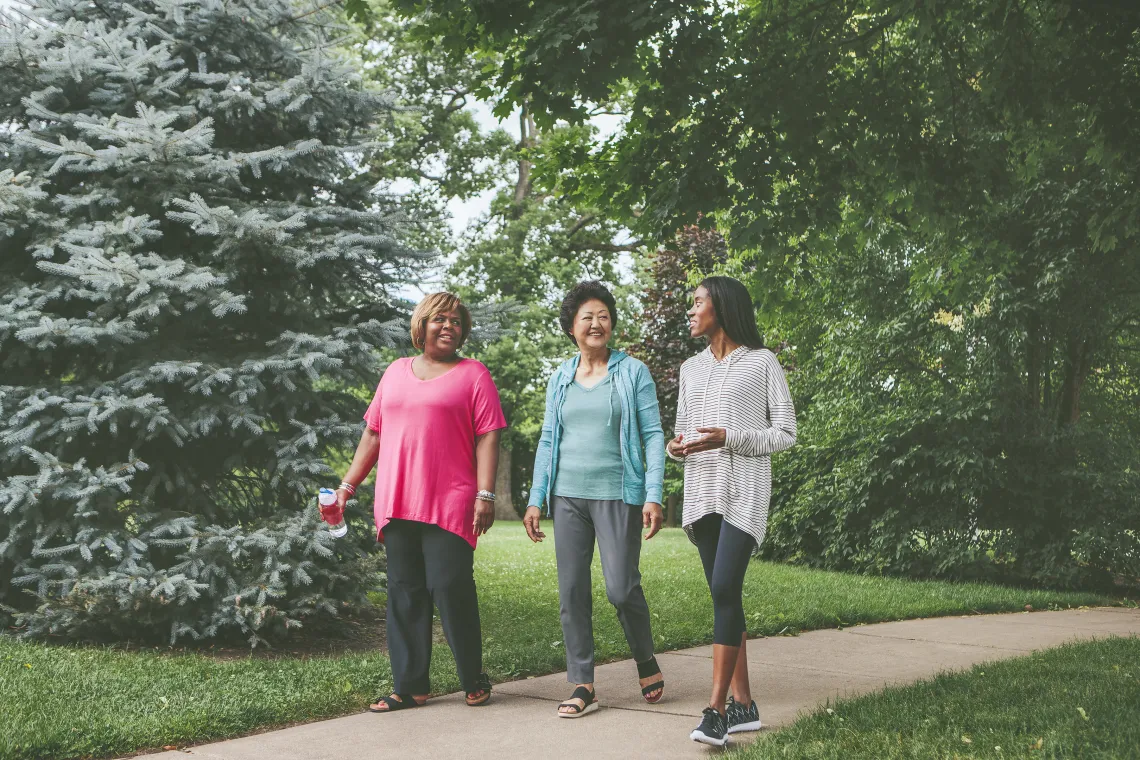 three adult women taking a walk together outside