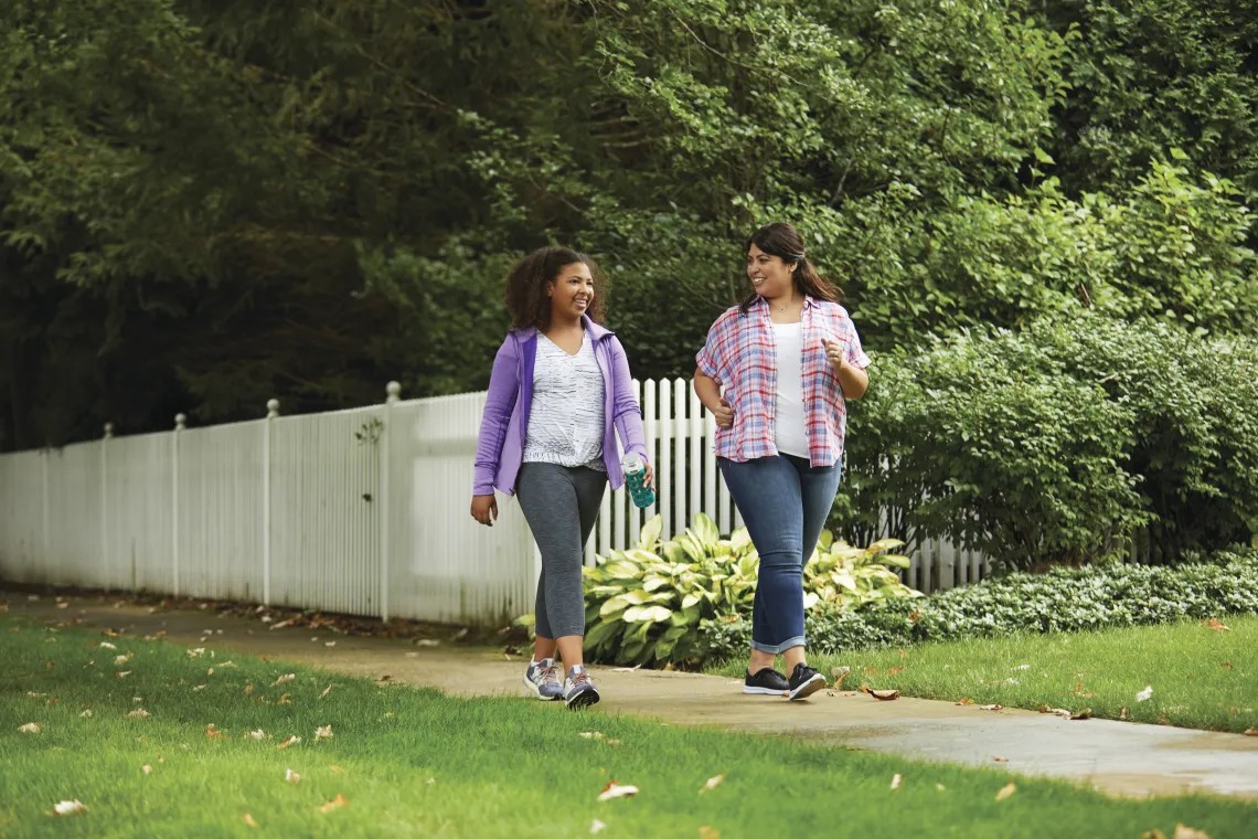 image of two women walking together outside