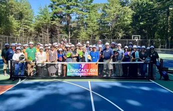 image of large group posing on pickleball courts