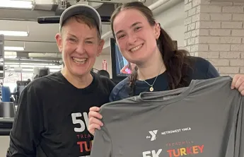 image of mother and daughter standing together in front of treadmills