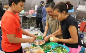 image of family cooking a meal during cooking class