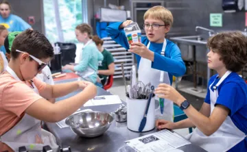 three boys mixing ingredients during cooking class