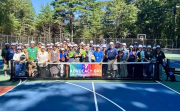 image of large group posing on pickleball courts