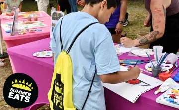 boy coloring at table