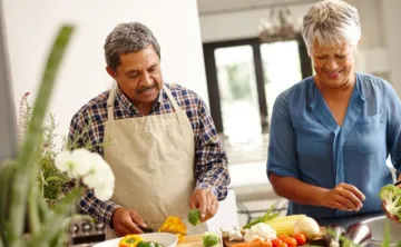 image of two older adults cooking