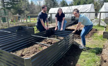 image of three volunteers working in the garden