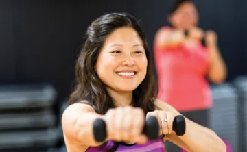 woman exercising with dumbbells