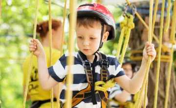 Little kid on MetroWest YMCA Hopkinton Outdoor Center Ropes Course