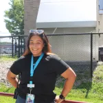 image of female camp staff member outside on a sunny day